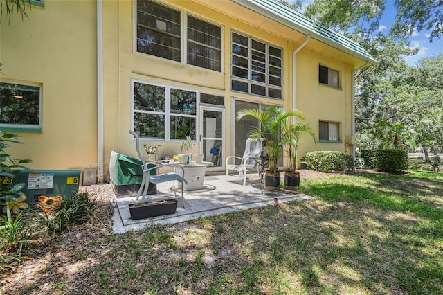 back of property featuring a patio area