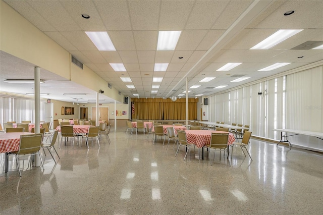 dining space with a drop ceiling