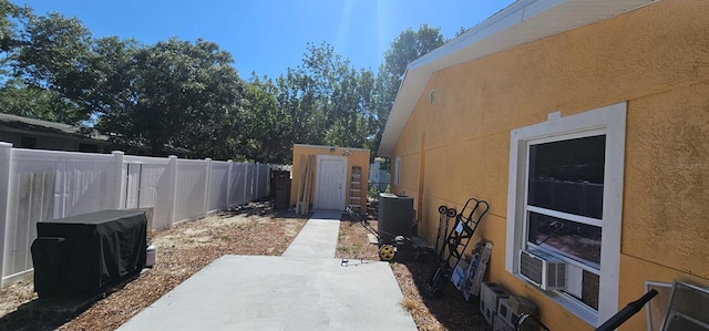 view of side of home with central air condition unit