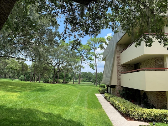 view of yard with a balcony