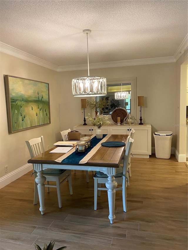 dining room with crown molding, a textured ceiling, and hardwood / wood-style flooring