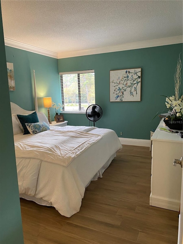 bedroom with ornamental molding, a textured ceiling, and dark hardwood / wood-style flooring