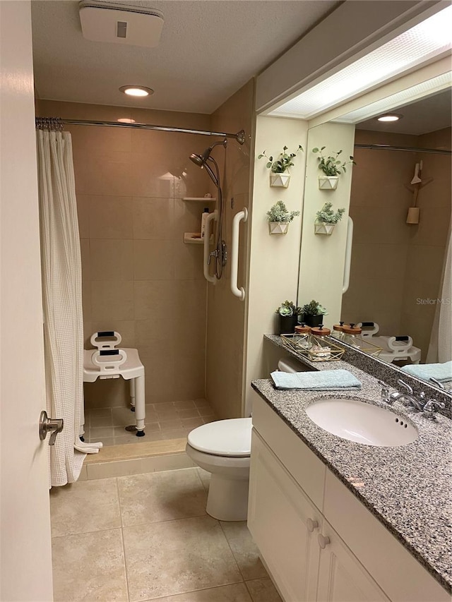 bathroom with vanity, curtained shower, tile patterned floors, and toilet