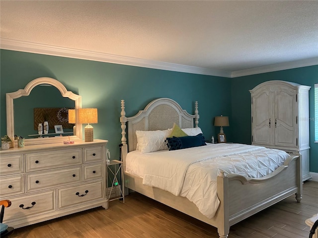 bedroom with hardwood / wood-style flooring, ornamental molding, and a textured ceiling