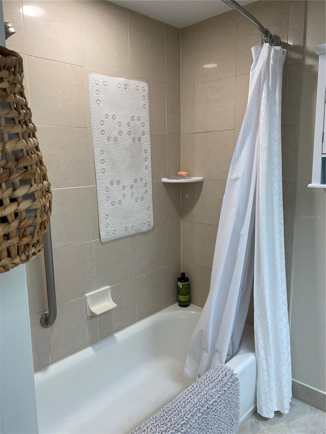 bathroom with shower / bath combination with curtain