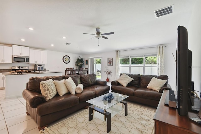 living room featuring ceiling fan and light tile patterned floors