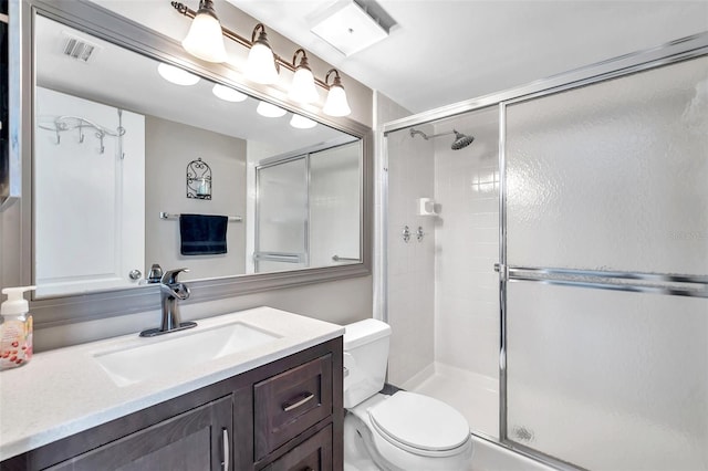 bathroom with vanity, toilet, and walk in shower