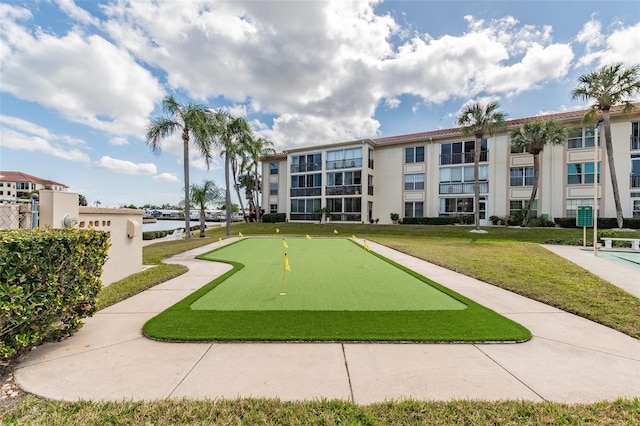 view of property's community with a lawn