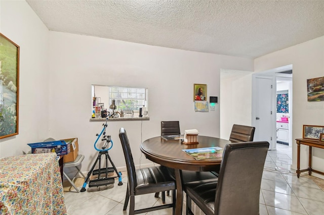 tiled dining room with a textured ceiling