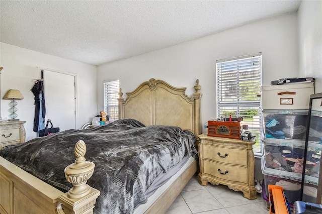 tiled bedroom with a textured ceiling