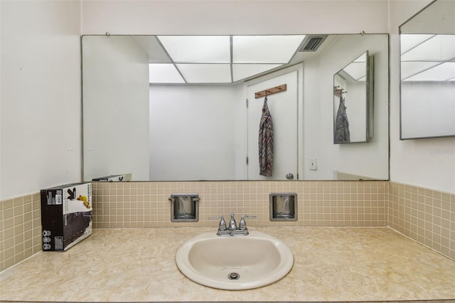 bathroom with sink and tasteful backsplash