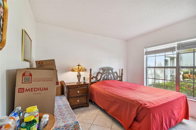 tiled bedroom with a textured ceiling