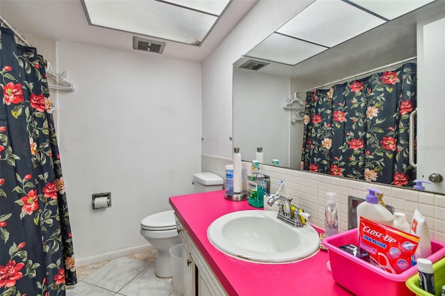 bathroom with tile flooring, tasteful backsplash, toilet, and large vanity