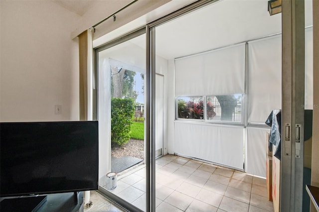 doorway to outside featuring light tile floors