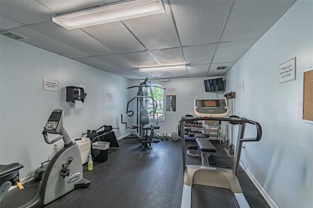 workout area with a paneled ceiling