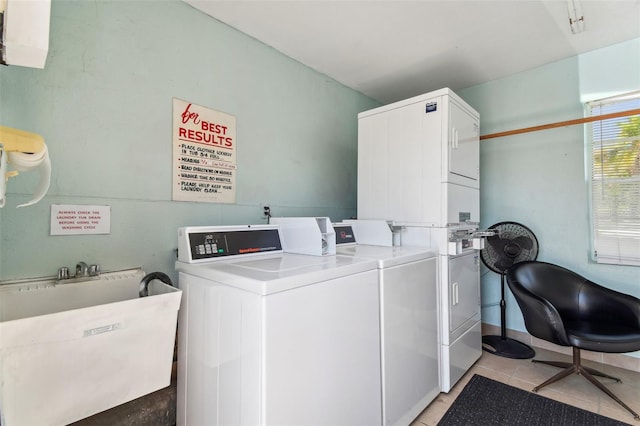 washroom featuring sink, stacked washer and dryer, and light tile floors