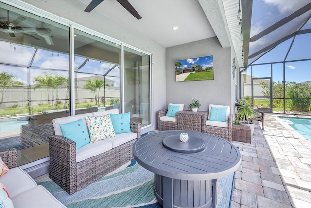 view of patio / terrace featuring ceiling fan, a fenced in pool, a lanai, and an outdoor hangout area