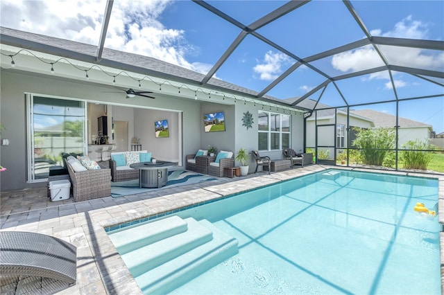 view of swimming pool with glass enclosure, a patio area, an outdoor hangout area, and ceiling fan