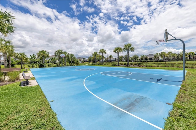 view of basketball court with a yard