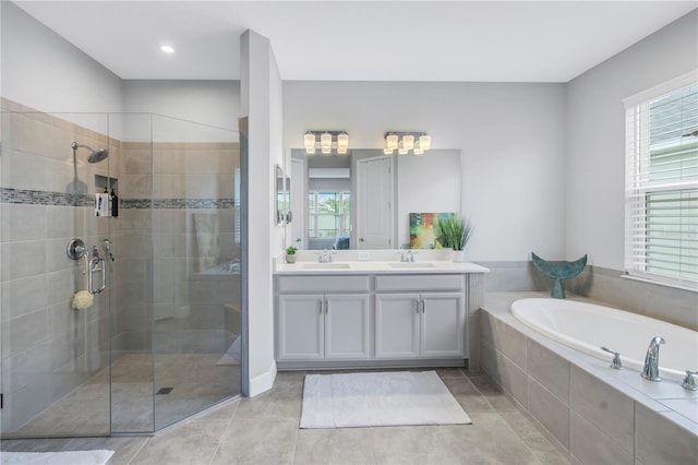 bathroom with vanity, tile patterned flooring, and plus walk in shower