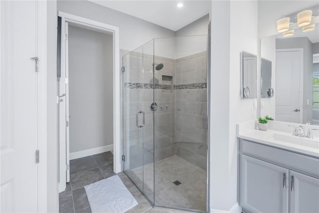 bathroom featuring vanity, a shower with shower door, and tile patterned flooring