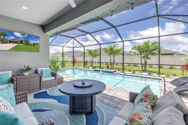 view of pool with a patio area and a lanai