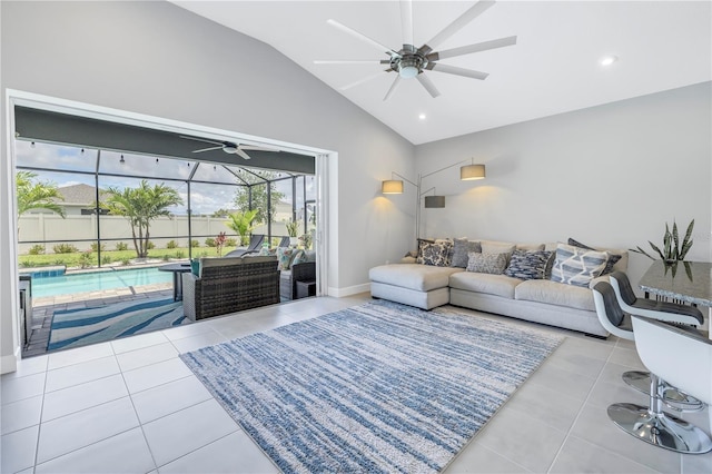 tiled living room featuring ceiling fan and lofted ceiling