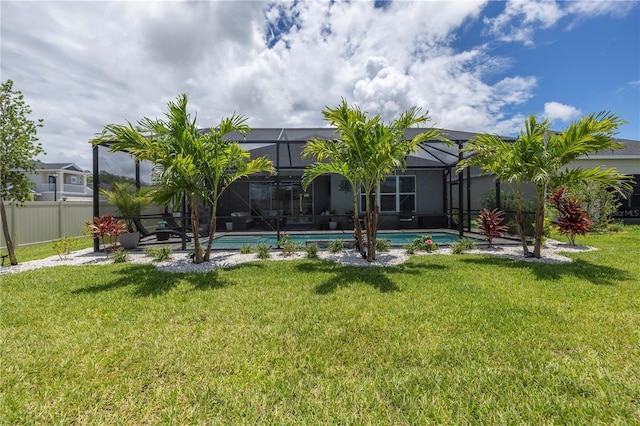 back of property featuring a lanai and a yard