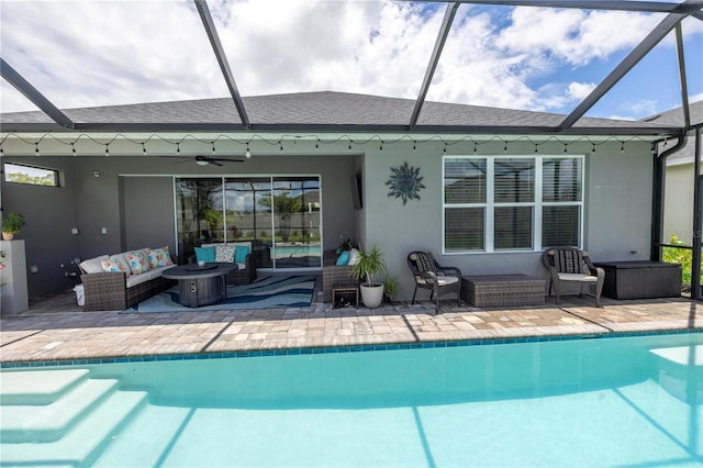 back of house featuring glass enclosure, ceiling fan, a patio, and an outdoor hangout area