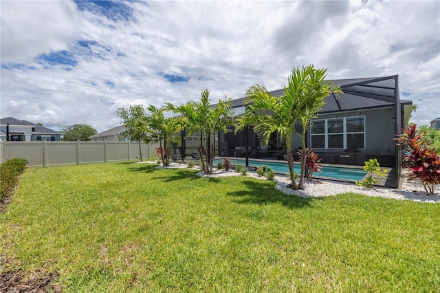 view of yard with a fenced in pool and a lanai