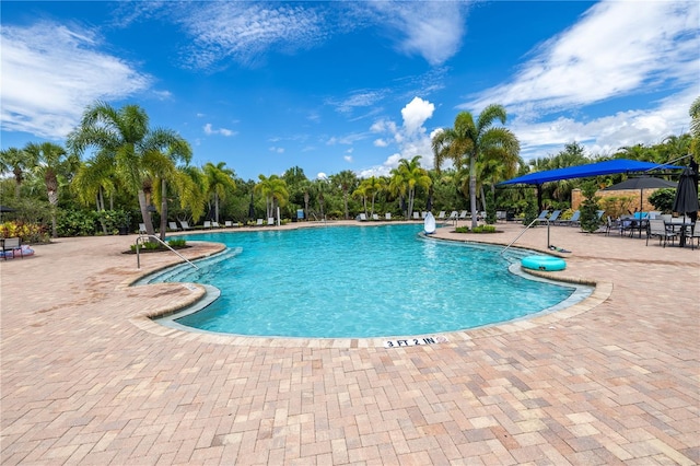 view of swimming pool featuring a patio area