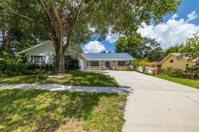 single story home featuring a porch and a front lawn