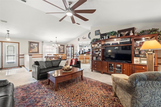 carpeted living room with ceiling fan with notable chandelier and lofted ceiling