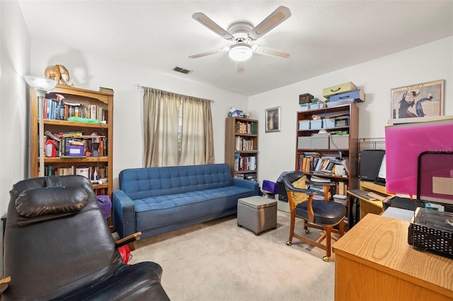 carpeted office space with ceiling fan