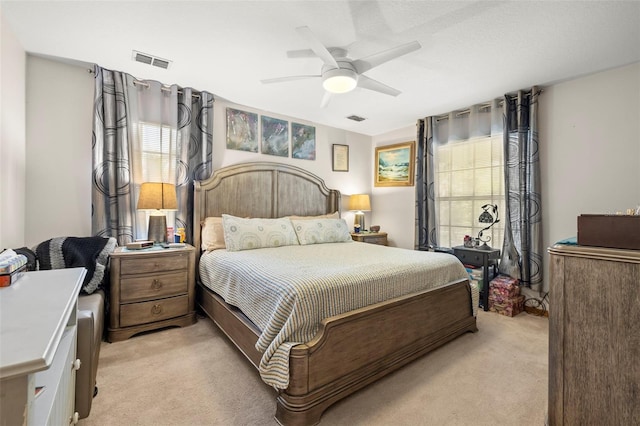 bedroom featuring ceiling fan and light colored carpet