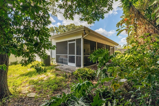 view of home's exterior with a sunroom