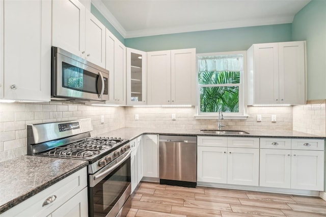 kitchen with white cabinetry, stainless steel appliances, and sink