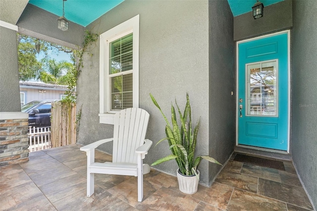 entrance to property with stucco siding