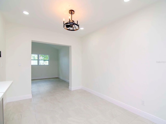 unfurnished dining area featuring a notable chandelier