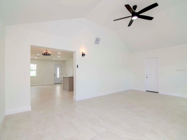 unfurnished room with lofted ceiling and ceiling fan with notable chandelier