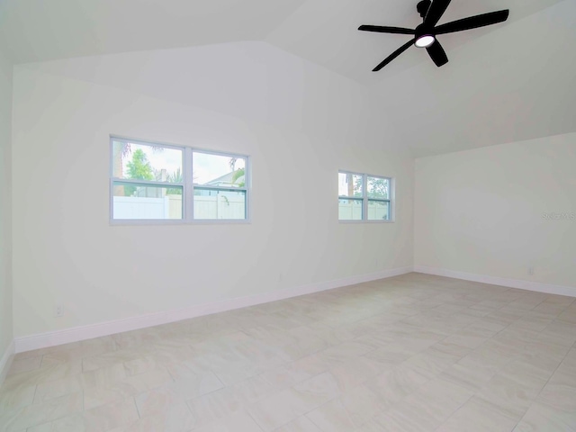 empty room featuring ceiling fan and lofted ceiling