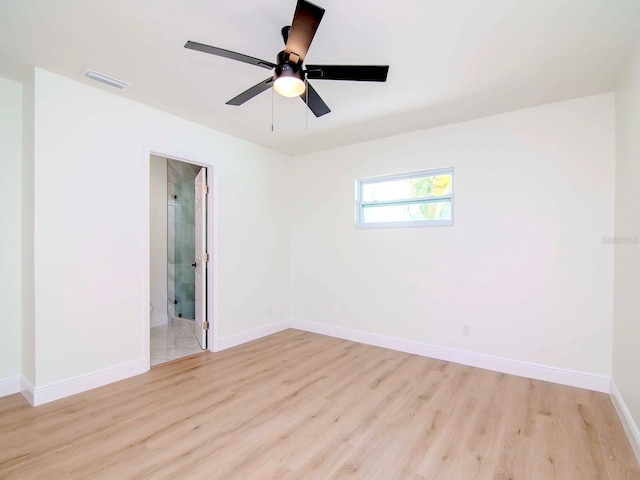 spare room with ceiling fan and light hardwood / wood-style floors