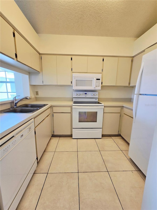 6802 Stones Throw Cir N Unit 14206, Saint Petersburg, FL 33710 - kitchen with white appliances, a sink, a textured ceiling, light countertops, and cream cabinets