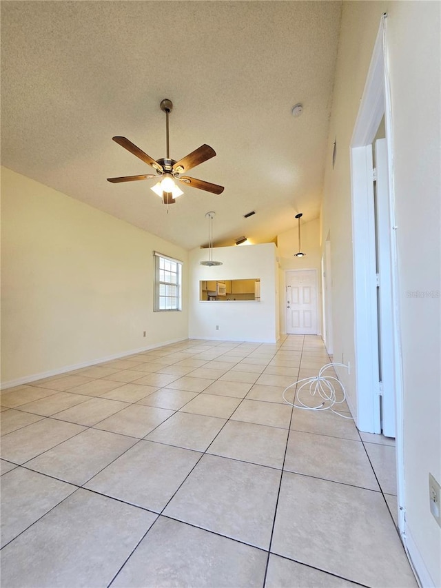 6802 Stones Throw Cir N Unit 14206, Saint Petersburg, FL 33710 - unfurnished living room with lofted ceiling, a textured ceiling, light tile patterned flooring, and a ceiling fan