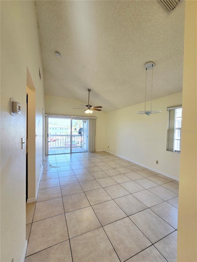 6802 Stones Throw Cir N Unit 14206, Saint Petersburg, FL 33710 - unfurnished room with a textured ceiling, ceiling fan, light tile patterned floors, baseboards, and vaulted ceiling