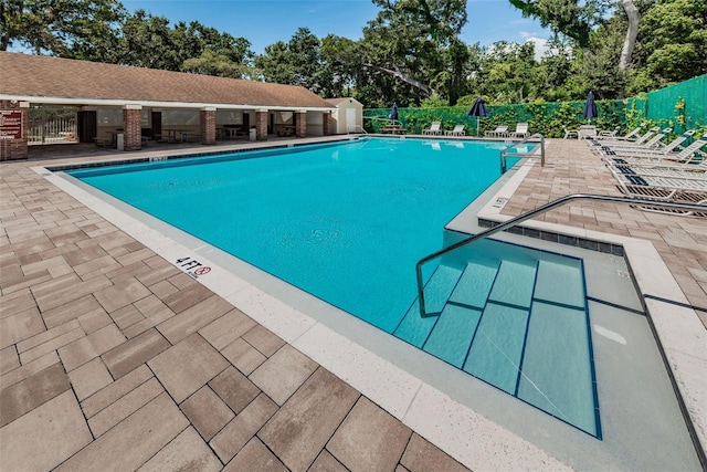 pool featuring a patio area and fence