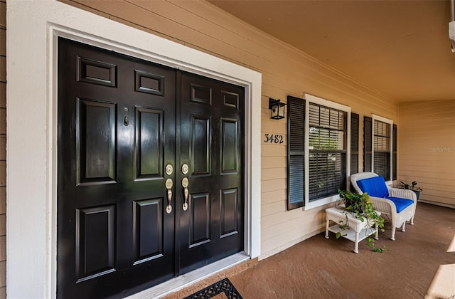 doorway to property featuring covered porch