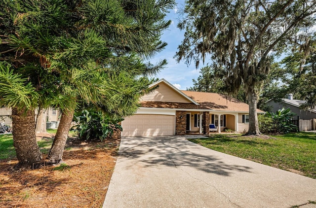 view of front of property featuring a front yard, concrete driveway, and an attached garage