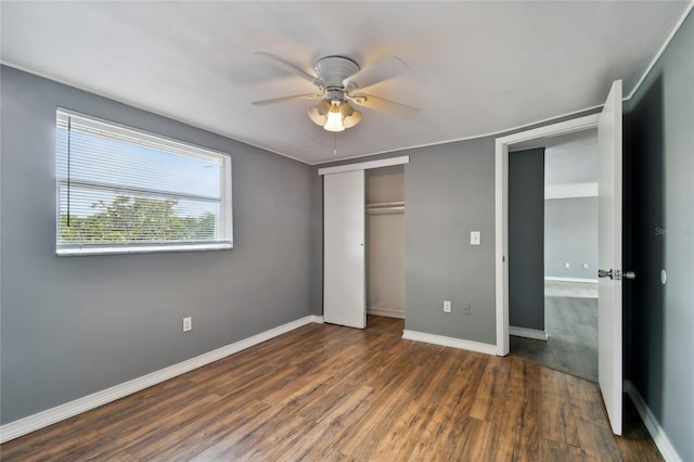 unfurnished bedroom featuring ceiling fan and dark hardwood / wood-style floors