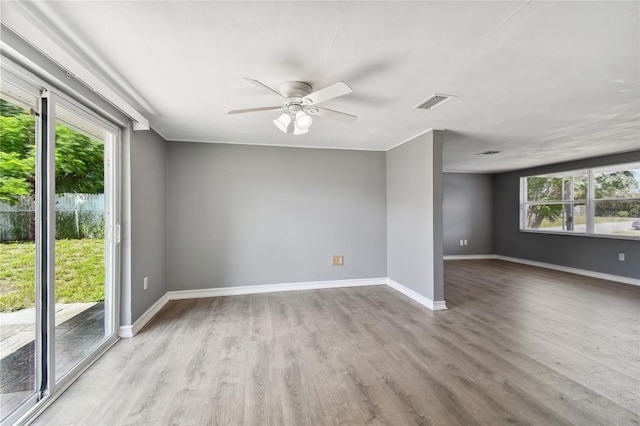 spare room featuring light hardwood / wood-style flooring and ceiling fan